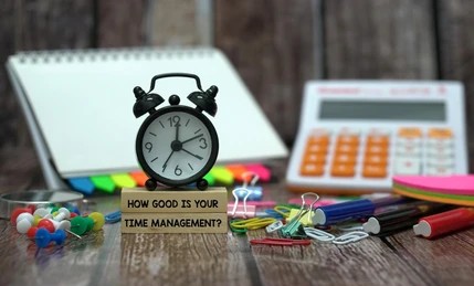 A clock and calculator placed together, symbolizing time management and maximum efficiency in planning