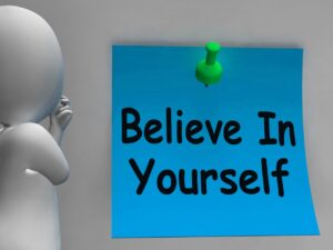 An image shows Unshakable Confidence with a text written on a note Believe in Yourself.